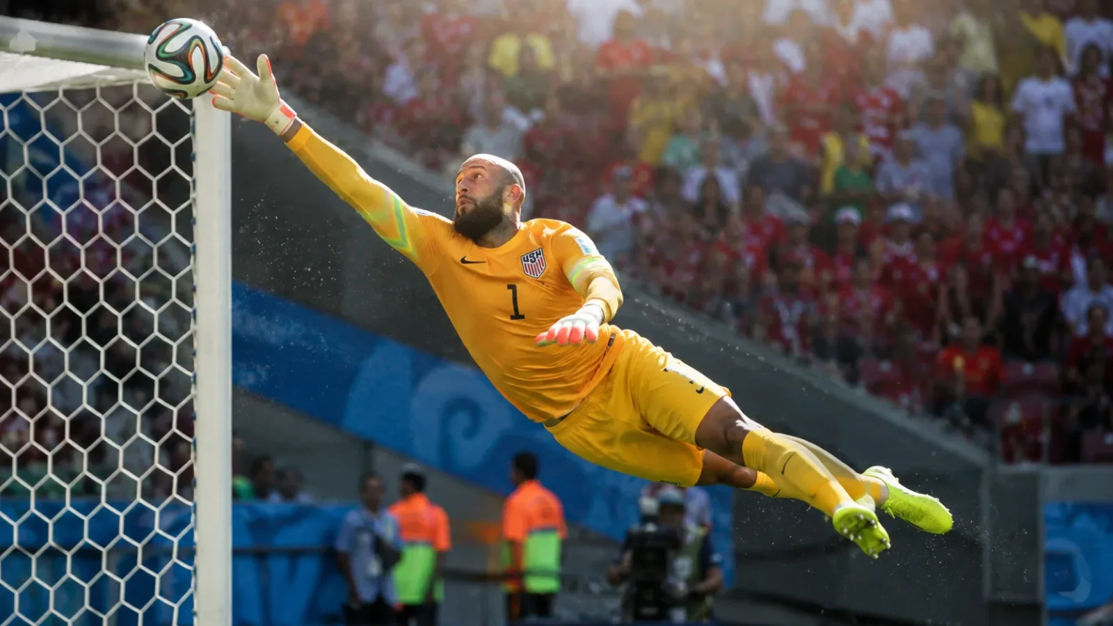 A dynamic action shot of goalkeeper Tim Howard making a record-breaking save for the USMNT at the World Cup.