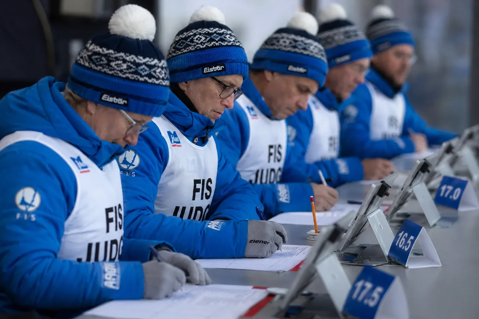 Ski jumping is not just about who flies the furthest. While distance is crucial, five international judges critically evaluate the athlete's flight trajectory, balance, and landing. The highest and lowest judges' scores are dropped, and the remaining three are added to the distance points to calculate the final score.
